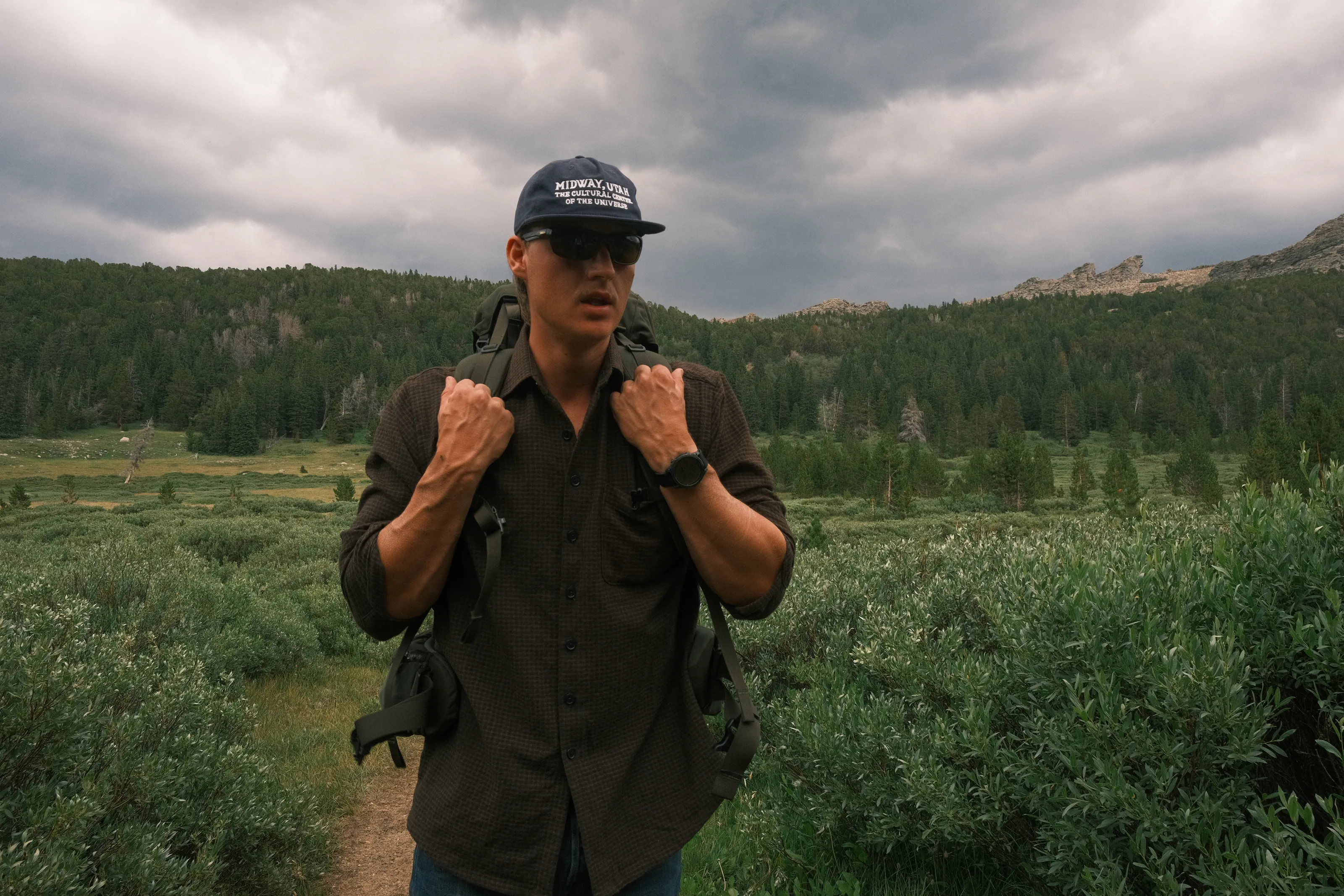 Jake Davis in a meadow under a storm sky