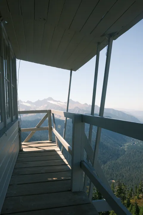 Fire lookout on a ridge below glaciated peaks