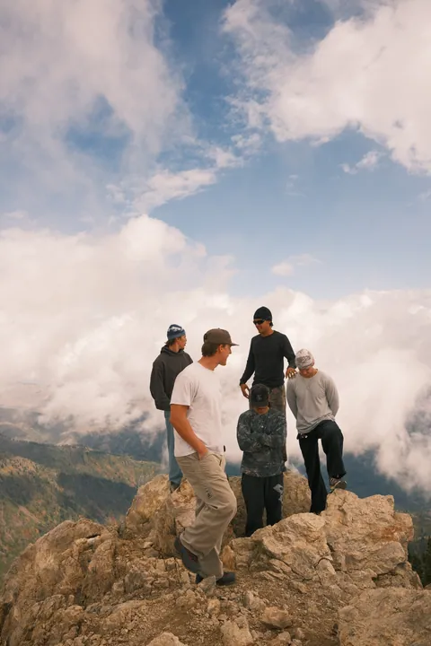 White 4Runner at a ridge-top lot in cloud, and friends on the summit of Ben Lomond